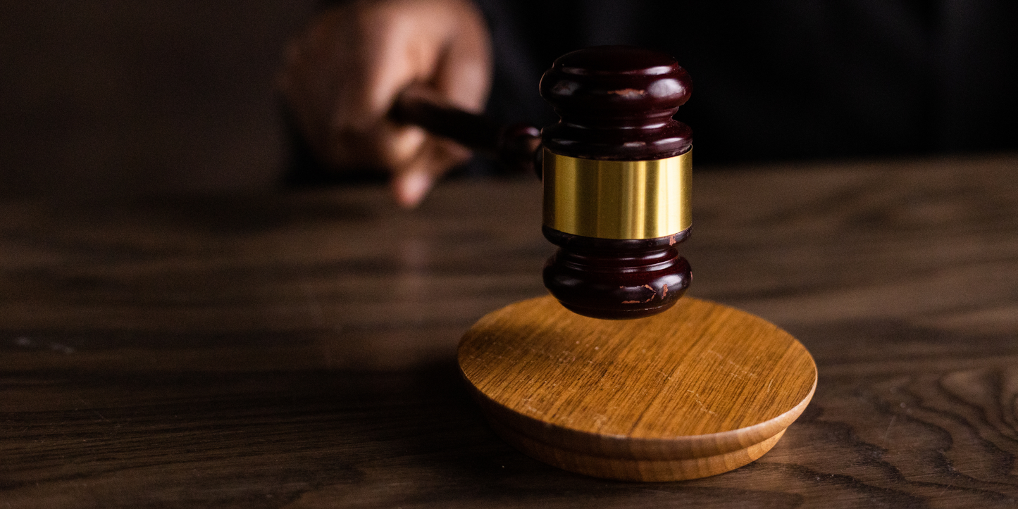 Close-up of hemp leaves with law books and court hammer symbolizing global hemp legalization